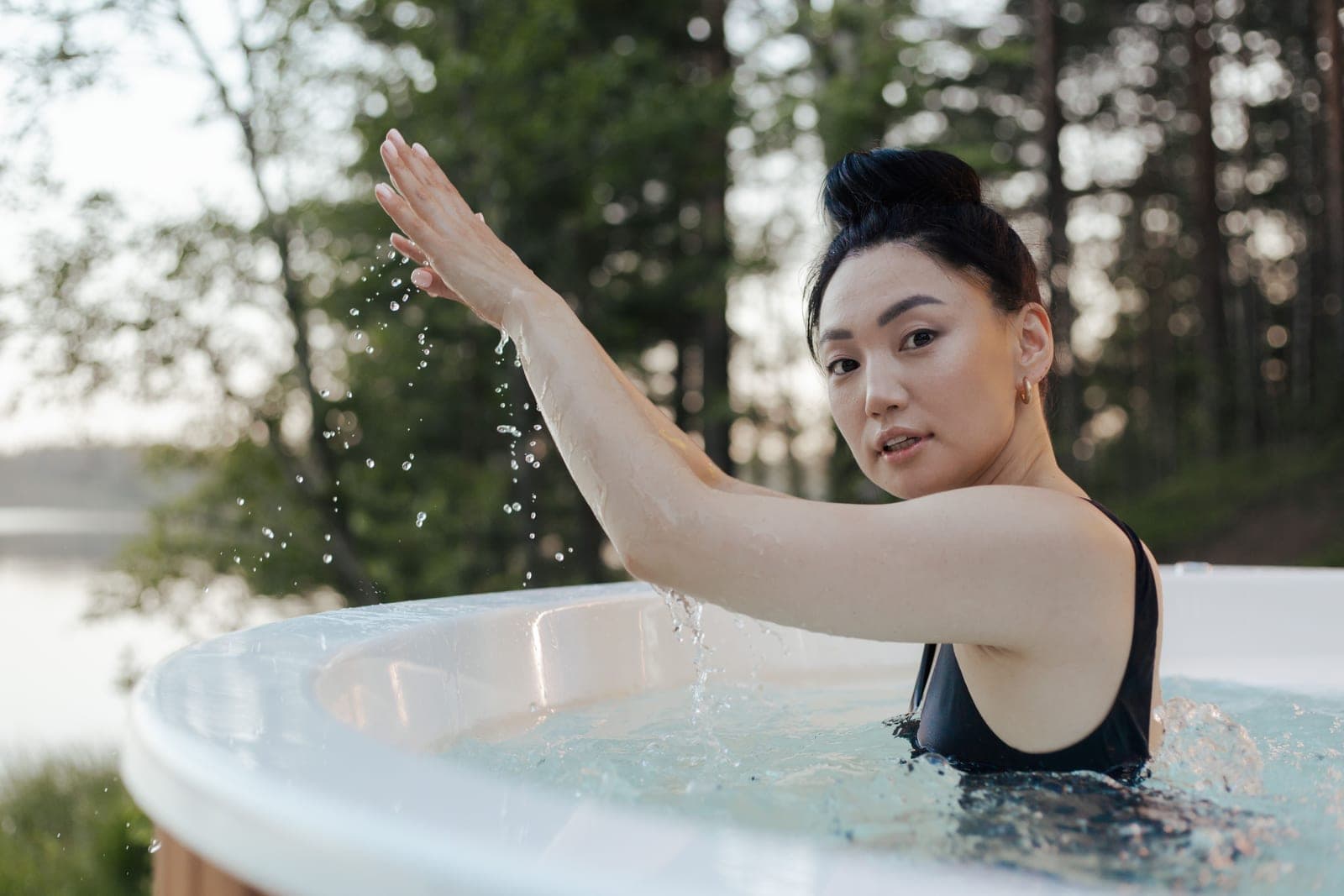 An inflatable cold plunge tub filled with cold water outdoors